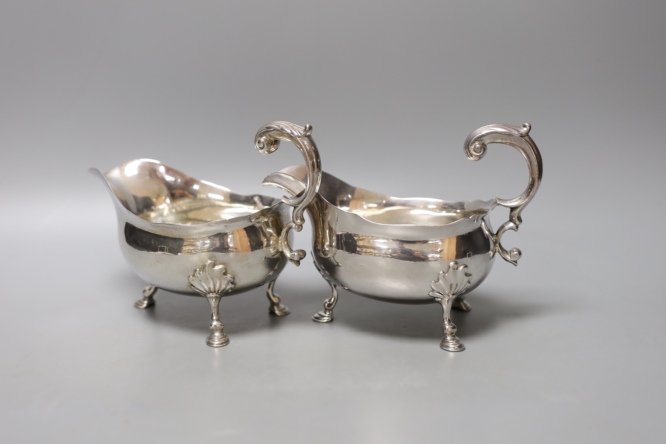 A pair of George II silver sauceboats, with flying scroll handles, maker's mark rubbed, London, 1752, height 12.8cm, 16.5oz.